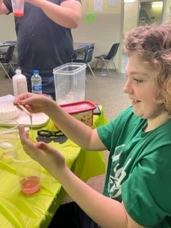 a student playing with slime