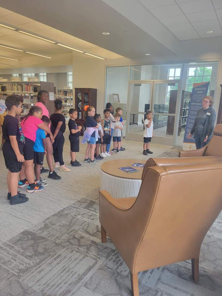 A group of children standing in line 