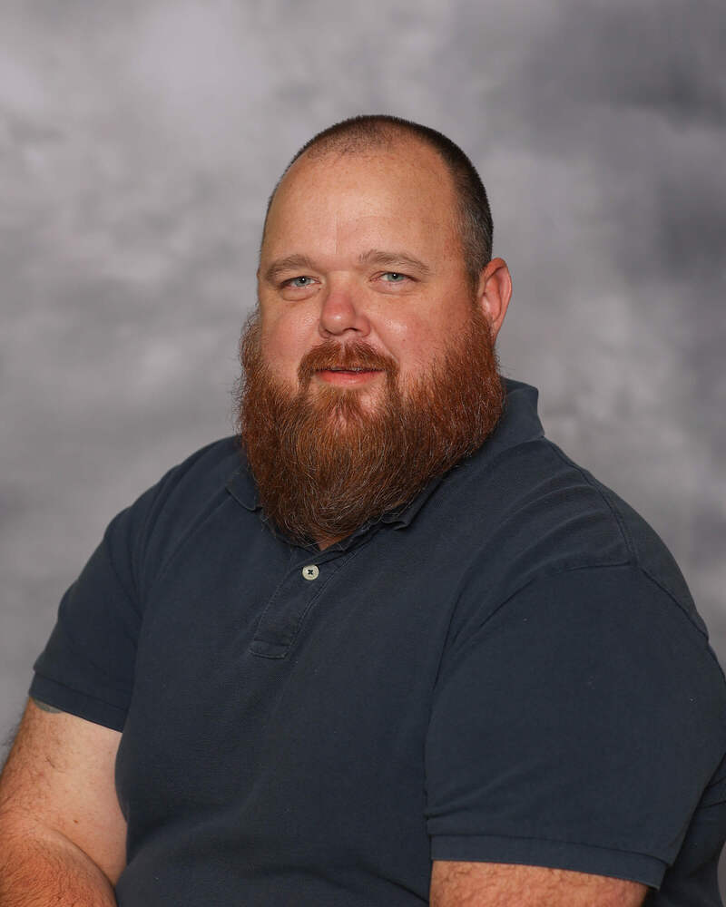 Bob Gallimore looks into the camera and gives a small smile for his headshot.