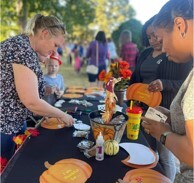 A group of ladies at a table putting crafts together.