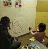 A young girl working on her Pumpkin Launcher.