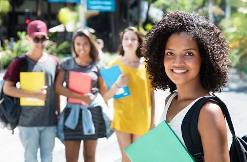 BJM Beyond Scholarship. Students standing outside.