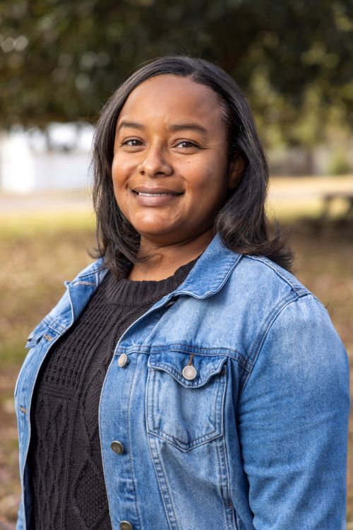 Kristy Robinson smiles a exuberantly for her headshot.