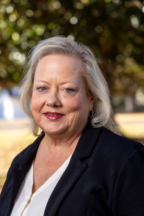 Pam Bratcher smiles a confident smile for her headshot.