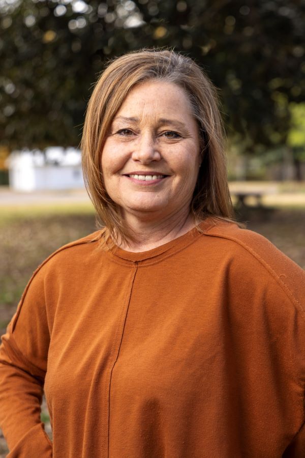 Rhonda Boyd peers into the camera and gives a soft smile.