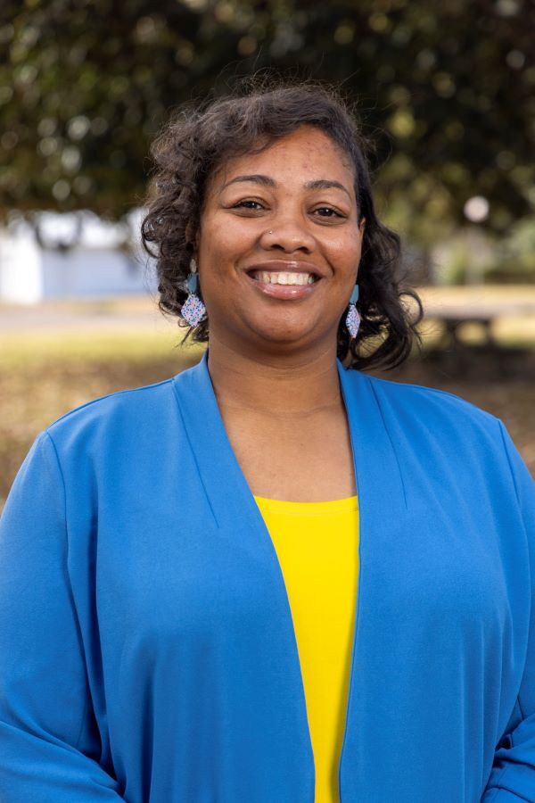 Jaclyn Marshall smiles a happy and confident smile for her headshot.